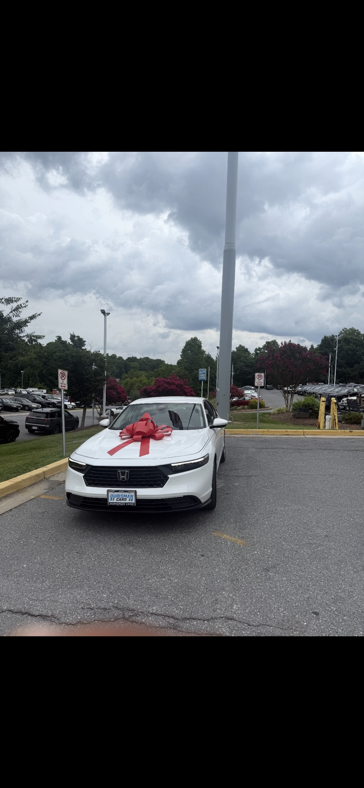White Honda sedan with a red bow