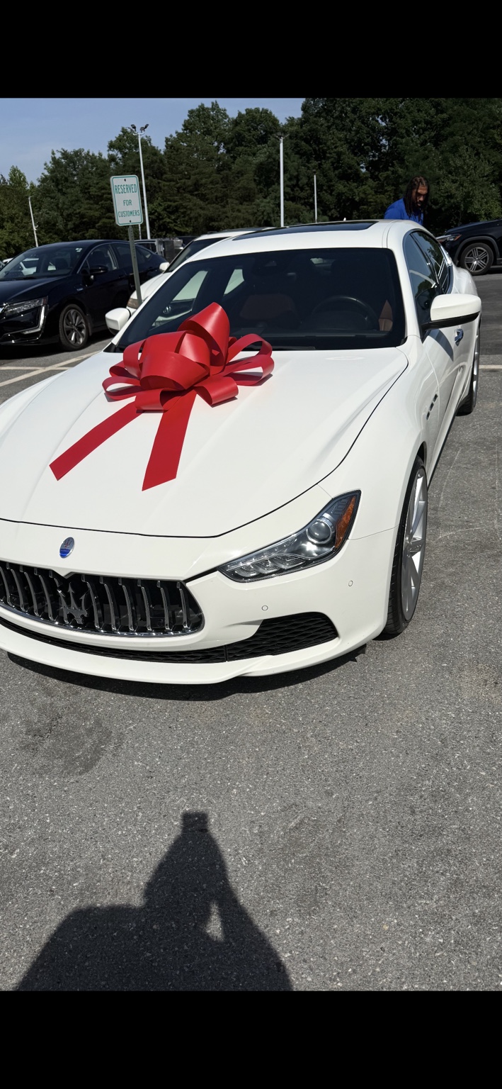 White Maserati with a red bow