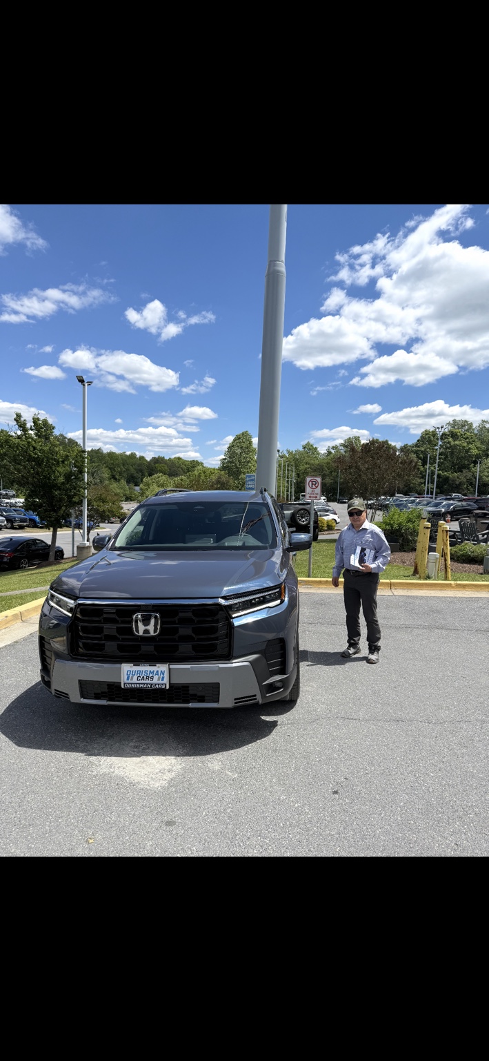 Customer beside a gray Honda SUV