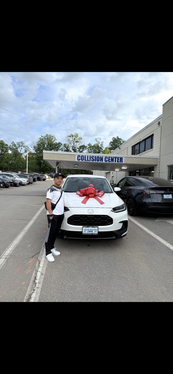 Customer beside a white Honda SUV with a red bow