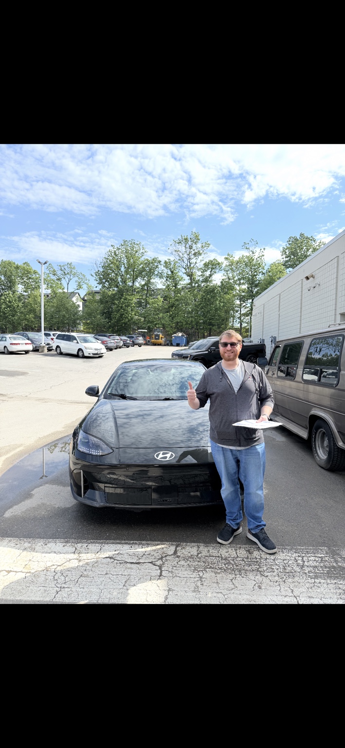 Customer beside a black Hyundai