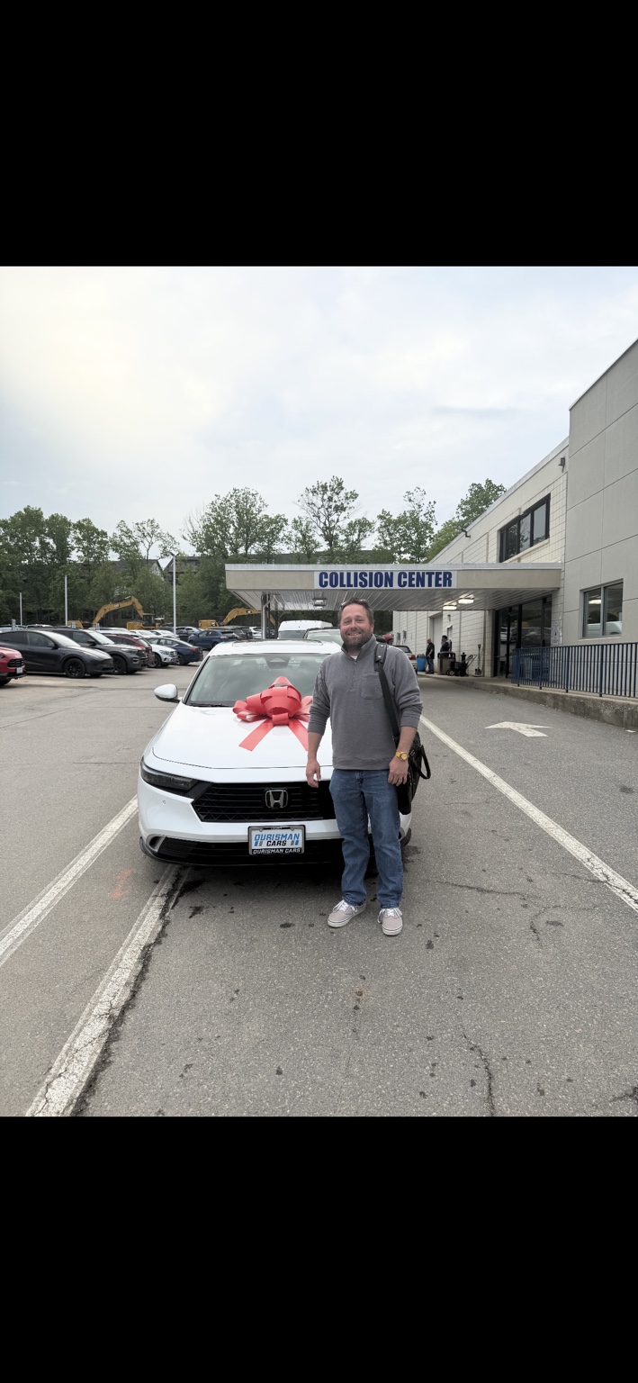 Customer beside a white Honda SUV with a red bow