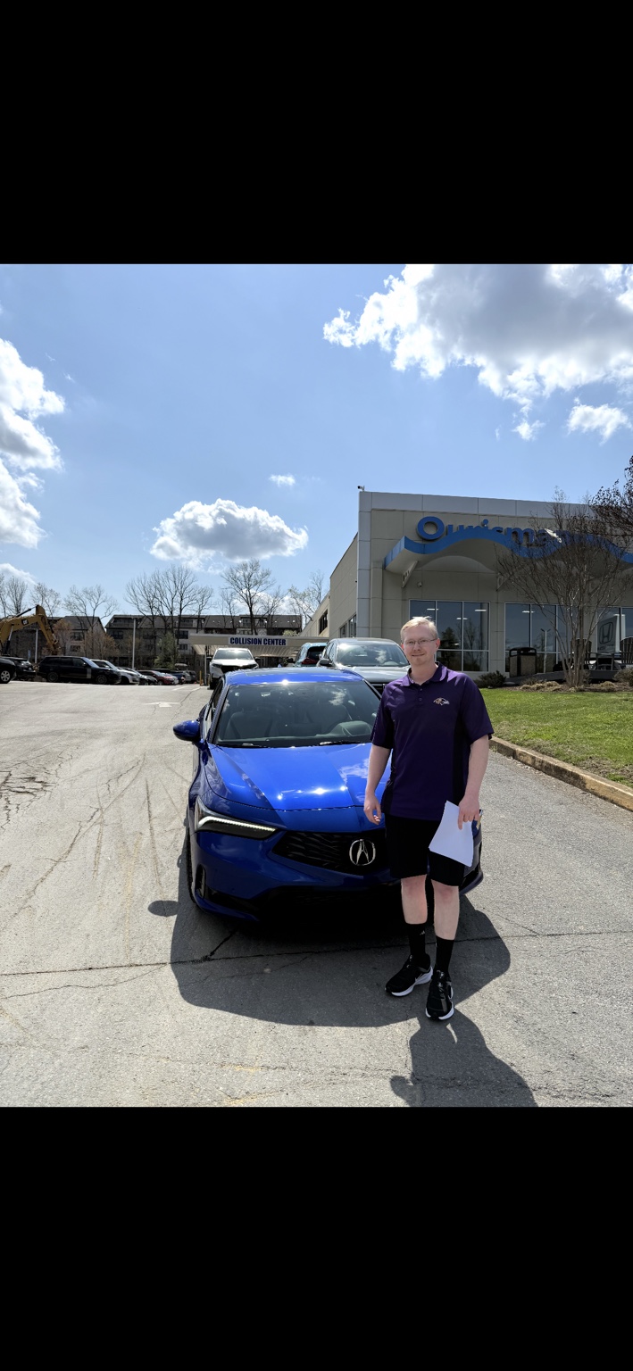 Customer beside a blue Acura sedan