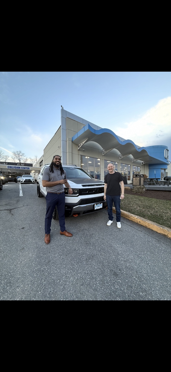 Customer and Jamel beside a white Honda pickup